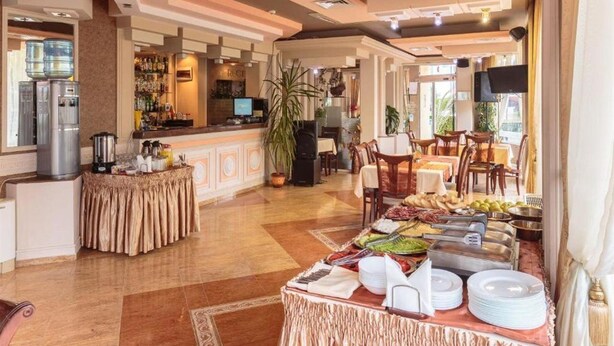 A hotel lobby with a buffet area, a reception desk, and a bar. - Imperial Hotel (Primorsko)