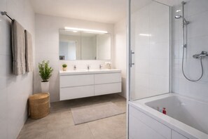A modern bathroom with a glass shower enclosure, a white vanity with a mirror, and a potted plant. - Mauerpark Mitte-Prenzl.Berg Penthouse, modern and authentic. 3 BR, 2 Bath (Berlin)