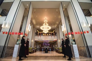 A grand lobby with a chandelier, marble flooring, and a reception desk. - Century Plaza Qidu Hotel (Zibo)