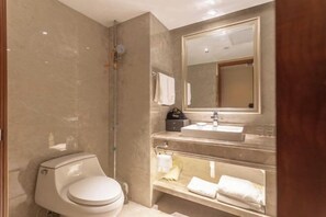 Un bagno moderno con il water, un lavandino e uno specchio.