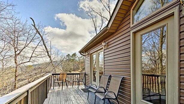A wooden deck with chairs, a glass door, and a view of trees. - Maple Highlands: Under 1 Mile to Lift! Mountaintop Estate with 2 Scenic Decks (McGaheysville)