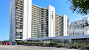 A high-rise hotel with multiple balconies, a prominent 'Palo Alto' sign, and a parking area in front. - DAILY ACTIVITIES & LINENS INCLUDED*! Lovely direct Oceanfront, 2 bedroom (Den converted to a third bedroom, there is a pocket door for privacy with a queen bed, closed from kitchen but open to entry) 2 bath condo. (Ocean City)