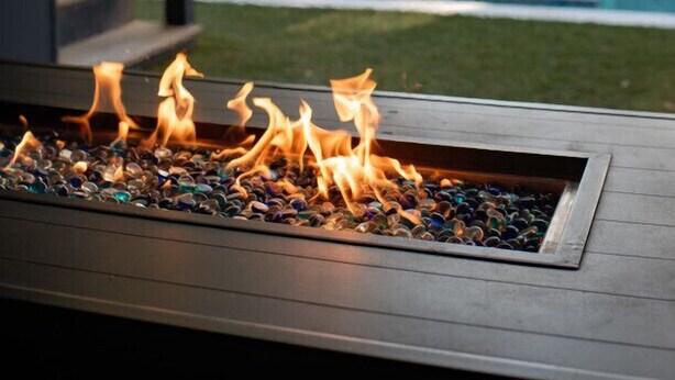 A poolside area with a fire feature and a view of a swimming pool. - Pool, Hot Tub & Perfect Fall Beach Days (Isle of Palms)