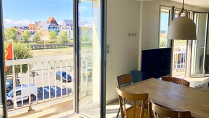 An open balcony with a view of a parking area and buildings. - TROUVILLE 3 Bdrms 65m2 SPLENDID AND CLEAR VIEW, BATHED IN LIGHT (Trouville-sur-Mer)