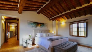 A bedroom with a large bed, a bench, a nightstand, and a painting on the wall. - Serena al Casalone, Design apartment in Private Chianti Estate, pool WIFI A/C (San Gusme)