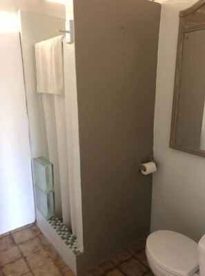 A bathroom with a toilet, a shower curtain, and a toilet paper holder. - Amazing View, 3 Bed Renovated, AC, Generator (St Thomas)