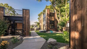 A modern residential building with a central pathway, wooden accents, and a well-maintained garden. - Pet-friendly, Cozy Tiny Home with Self Check-In and Wifi! (Spokane)