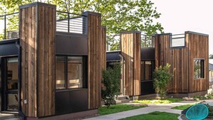 A modern building with wooden paneling and large windows. - Pet-friendly, Cozy Tiny Home with Self Check-In and Wifi! (Spokane)