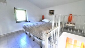 A single-bed room with a window, a bedside table, a chair, and a picture on the wall. - Mild hills Villa, on the Tuscany coast with brand new panoramic private pool (Camaiore)