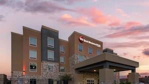 A multi-story hotel with a stone facade and a sign reading "Best Western Plus." - Best Western Plus McPherson (McPherson)