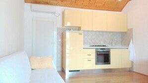 A compact kitchen with a built-in oven, a sink, and a stove. - Holiday Home Maćus-One Bedroom Apartment with Balcony (Kolocep)