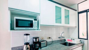 A modern kitchen with a built-in microwave, a toaster, a blender, and a sink. - Nice Apartment Malecon Balta Miraflores (Lima)