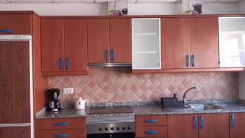 Een koelkast, een oven, een kookplaat, een koffiezetapparaat/waterkoker