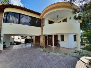 Stylish two-story building with a covered entrance and a balcony above.