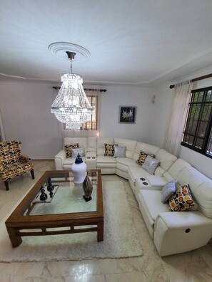 Relax in the spacious living room with a plush sectional sofa and a stylish coffee table.