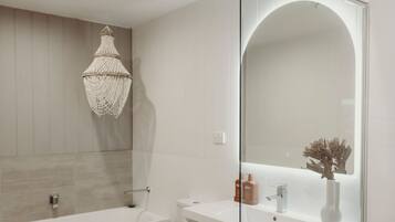 Bathtub, towels, soap, toilet paper