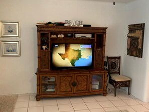 Enjoy entertainment and relaxation in this cozy space with a flat-screen TV and comfortable seating.