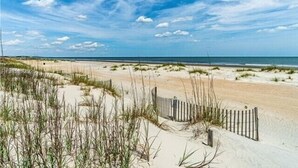 A sandy beach with dunes and a wooden fence. - Sunset Rentals | South Live Oak 25 (Hilton Head Island)