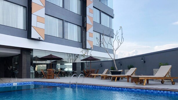 Um hotel moderno com piscina, área de estar externa e restaurante.
