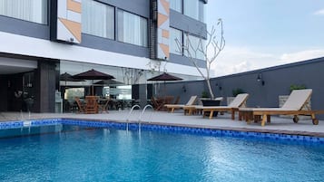 Outdoor pool, open 6:00 AM to 7:00 PM, pool loungers