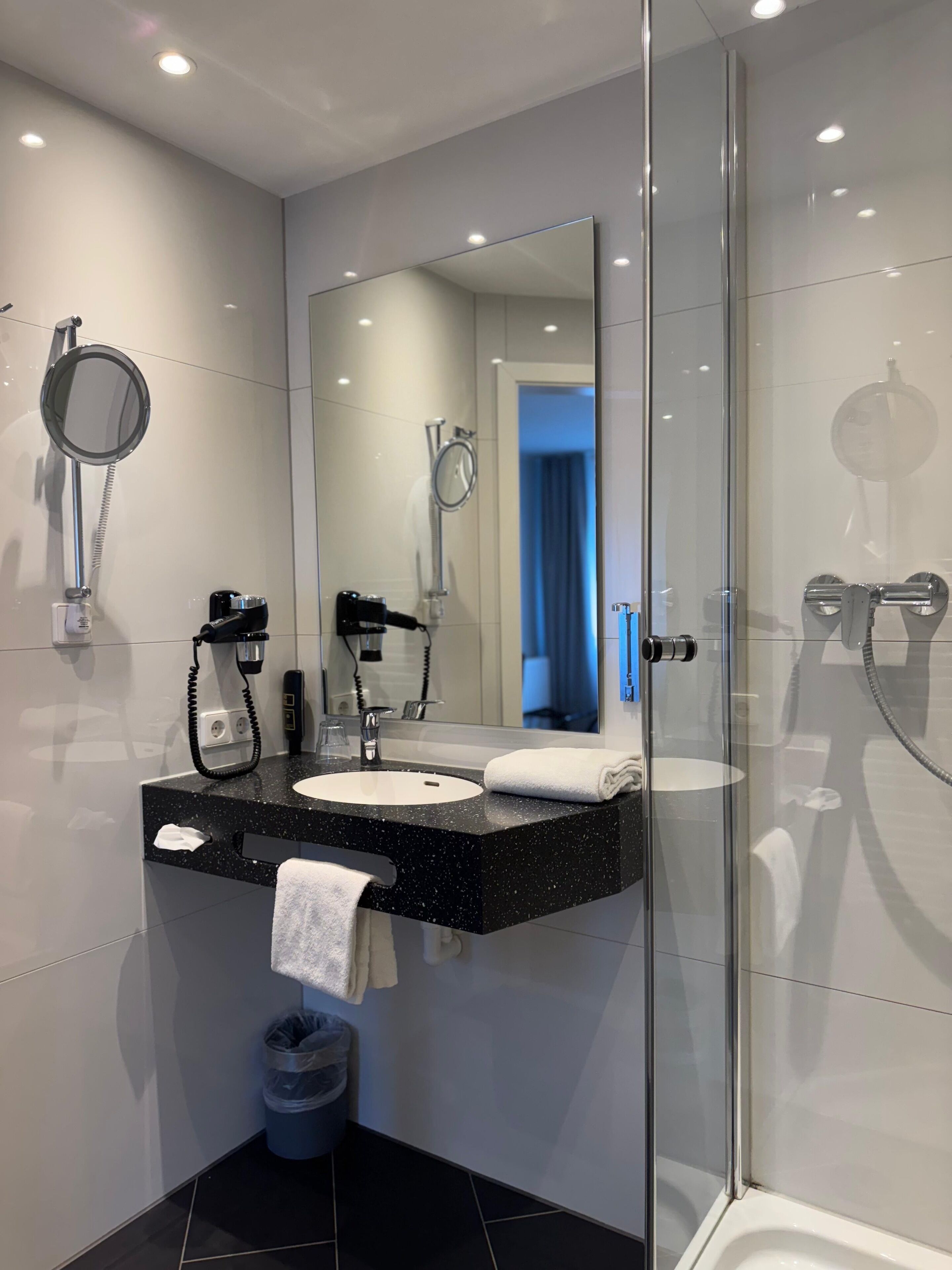 superior single room | bathroom | shower, hair dryer, towels, soap