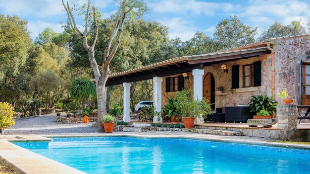 A pool area with a stone building, outdoor furniture, and potted plants. - Holiday Home 'Can Pedro Monjo' with Private Pool, Private Terrace and Wi-Fi (Alcudia)