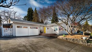 A single-story house with a garage, a front porch, and a driveway.