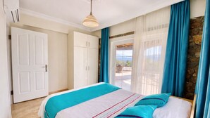 A bedroom with a bed, a wardrobe, a door, and a view through a window. - Stunning Villa Semira, Perfect Condition, Private Pool & 1000m2 Garden,WIFI (Muğla)