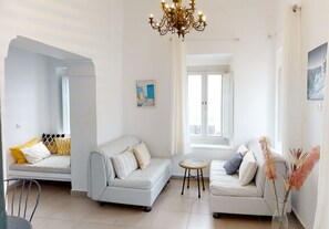 Family Apartment, Sea View | Living area | 50-inch Smart TV with digital channels, TV - Neoklassiko Koukouli (Santorini)