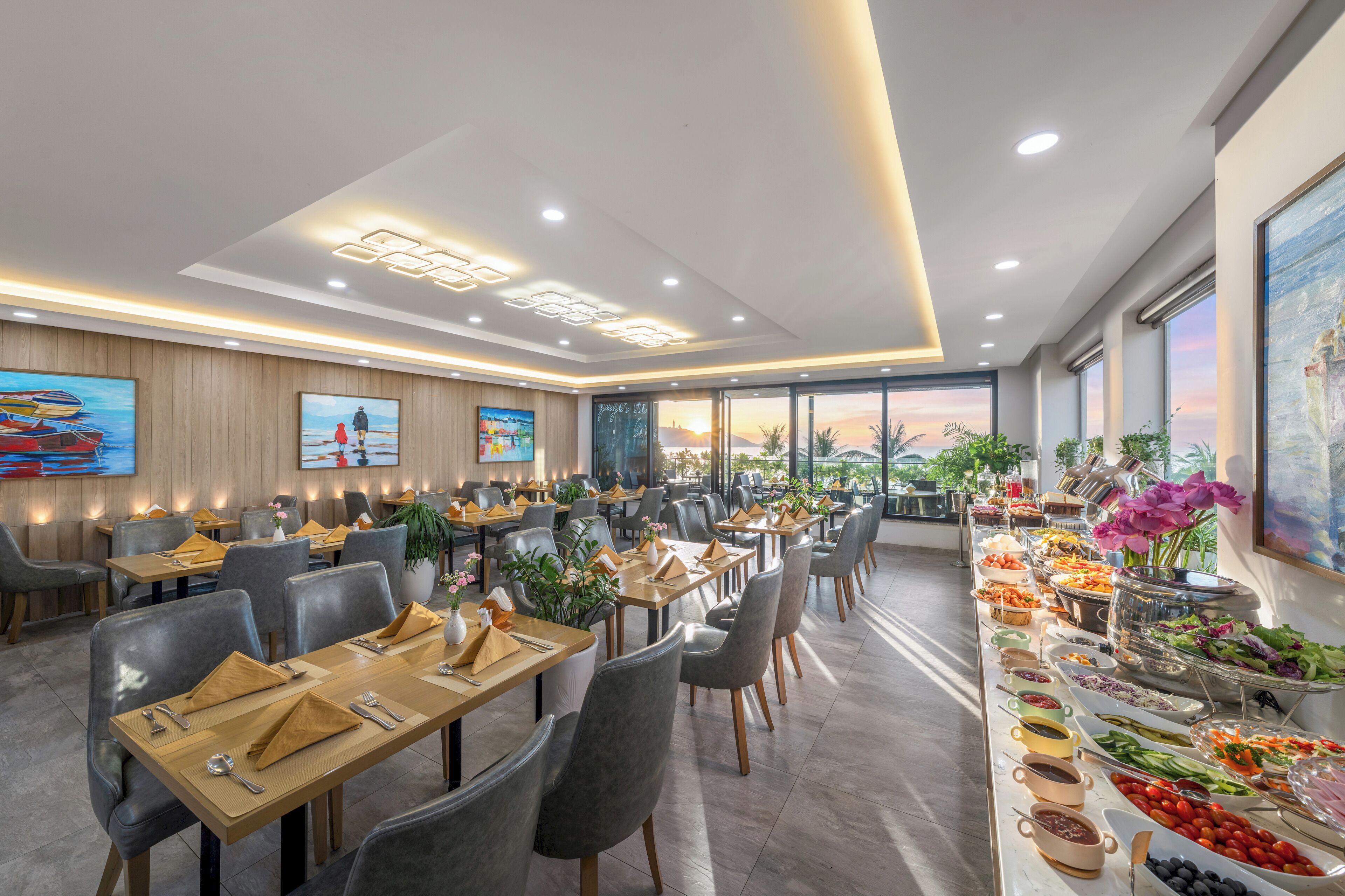A restaurant with multiple dining tables, chairs, and a buffet area with various food options.