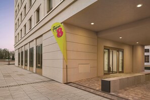 A hotel entrance with a large sign, a glass door, and a tiled pavement. - Super 8 by Wyndham Chemnitz (Chemnitz)