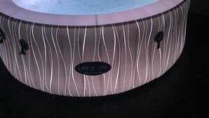 A spa hot tub with a wavy pattern design, a control panel, and a logo that reads "Lay-Z-Spa Hollywood". - Cumberland stable lodge  (Workington)