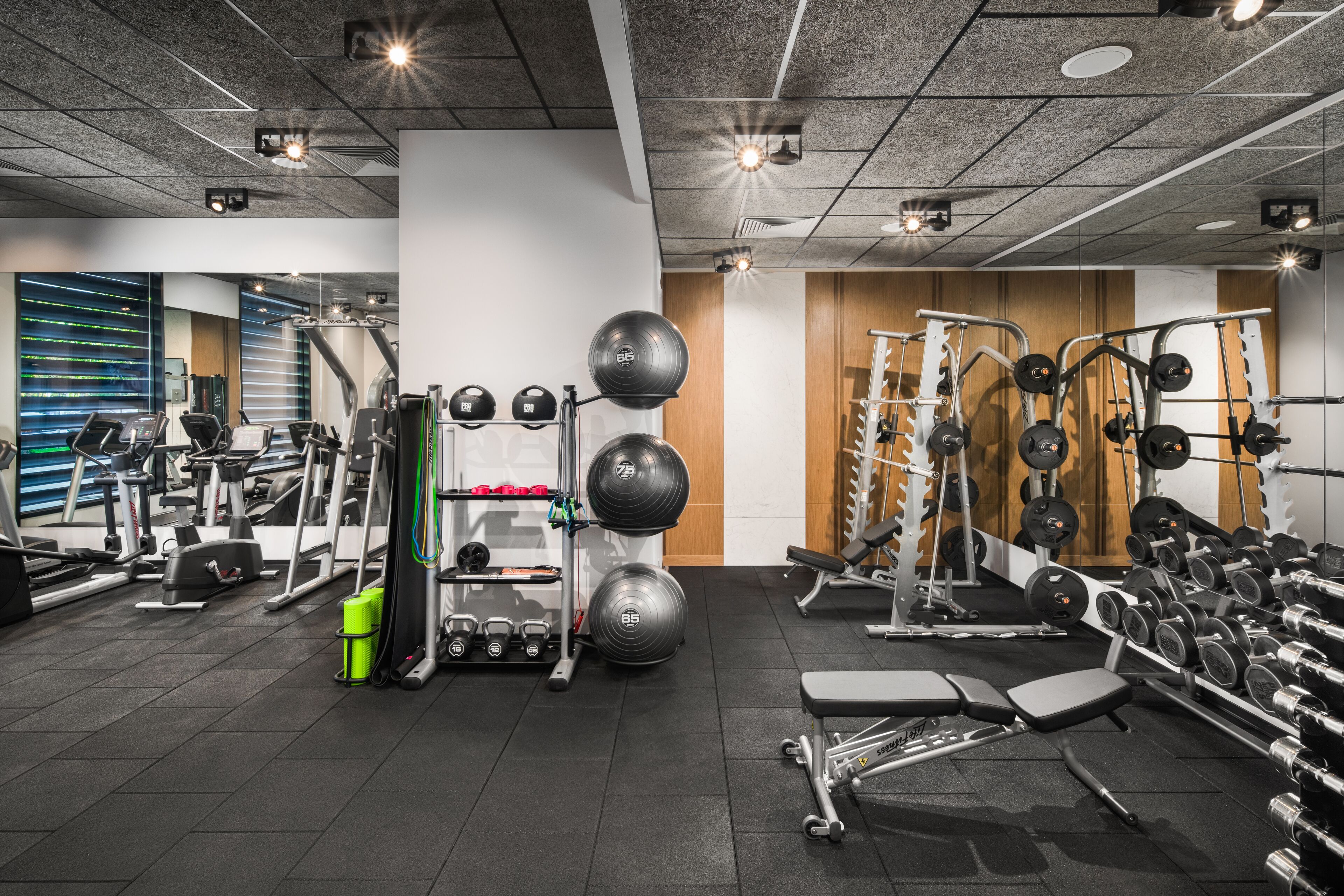 Et fitnesscenter med forskellig træningsudstyr, løbebånd og styrkemaskiner.