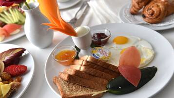 Un plato de desayuno con tostadas, huevos, salmón y mermelada.