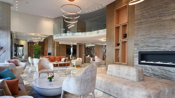 A spacious lobby with modern furnishings, a fireplace, and a glass railing overlooking the interior. - Flower Town Hôtel & Spa (Rabat)