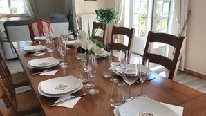 A dining table set with plates, glasses, and cutlery, surrounded by wooden chairs. - Charming 220m² Villa, 5 bedrooms, pool (heated), in Provence, 4-star **** rated (Bollène)