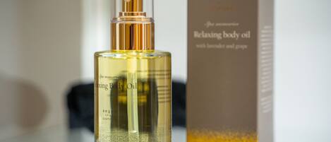 A bottle of relaxing body oil with lavender and grape.