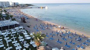 On the beach, white sand, sun loungers, beach umbrellas