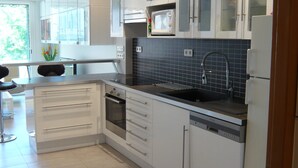 A modern kitchen with white cabinets, a built-in oven, a microwave, and a dishwasher. - 2 /3 ROOMS NEAR BEACH AND CONVENTION CENTER 4 PEOPLE MAXIMUM (Alpes-Maritimes)