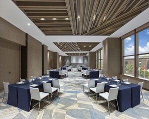 A conference room with a modern design, featuring a geometric patterned carpet, white chairs, and tables set for meetings. - Hyatt Regency Shanghai Songjiang (Shanghai)