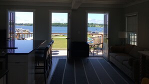 A spacious living area with a view of a marina and water.