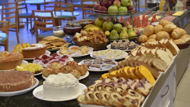 A buffet with various pastries, fruits, and desserts. - Hotel Villa Aconchego (Gramado)