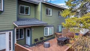 A two-story house with a deck, a patio with outdoor furniture, and a mailbox. - On Free City Bus Route! Hot Tub! Fireplace! (Steamboat Springs)