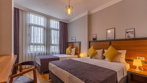 A hotel room with two beds, a desk, and a chair. - Business Hotel Antalya (Antalya)