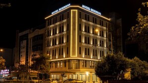 A multi-story hotel with a classic architectural design, featuring a prominent "HOTEL BUSINESS" sign at the top. - Business Hotel Antalya (Antalya)