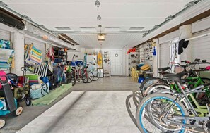 A garage with bicycles, shelves, and storage units.