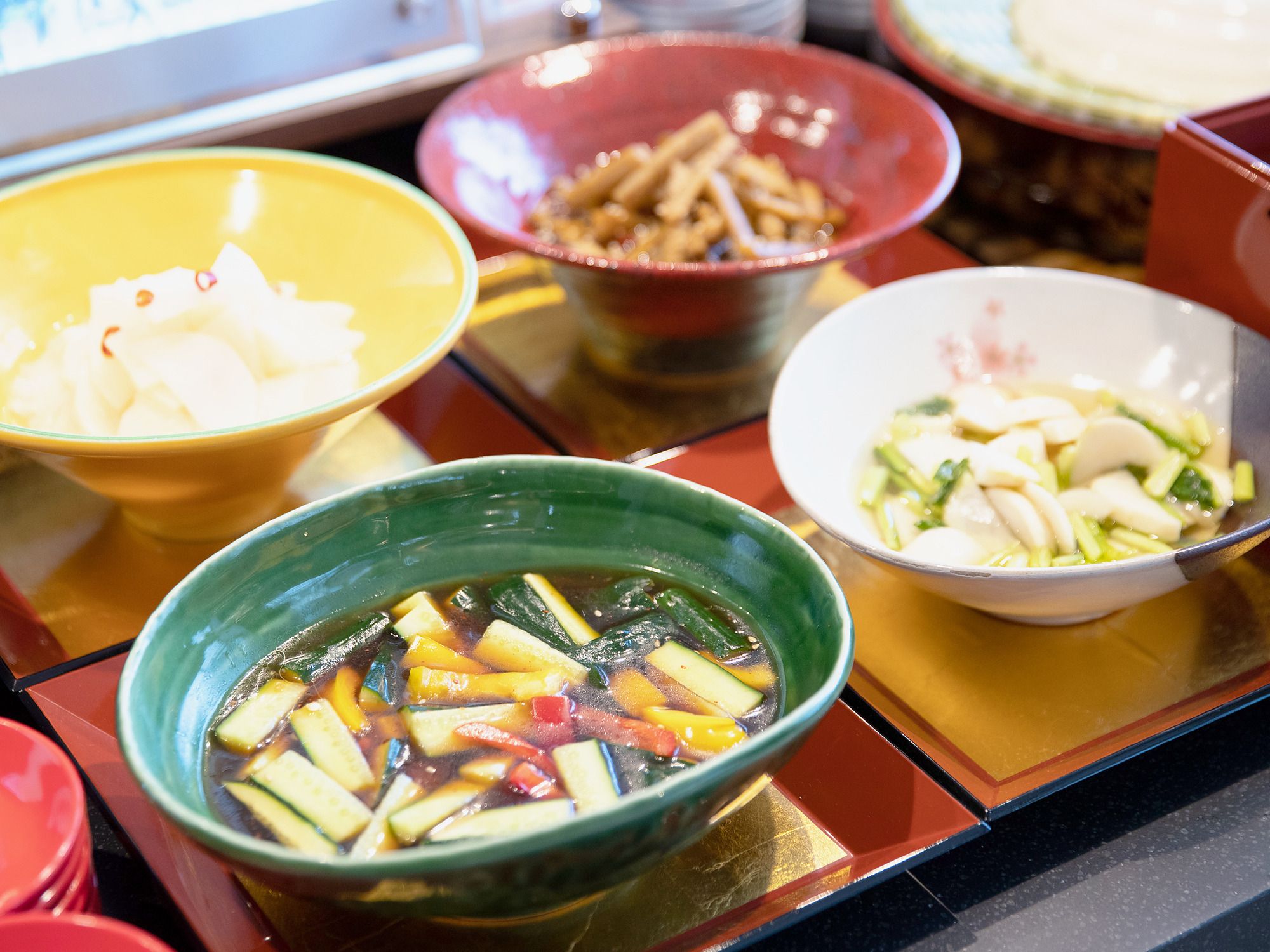 A variety of dishes in bowls on a table.