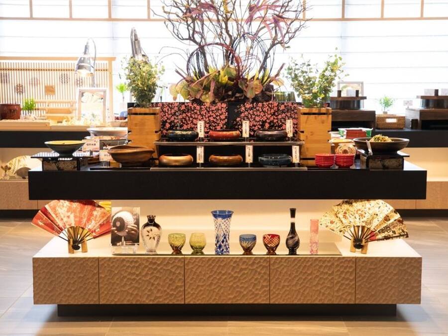 A reception area with a wooden counter, various decorative items, and a large window in the background.