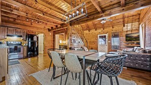 A spacious log cabin interior with a dining area, kitchen, and living room. - Log Cabin w/Hot Tub & All the Amenities. Close to the Park & Pigeon Forge (sevierville)
