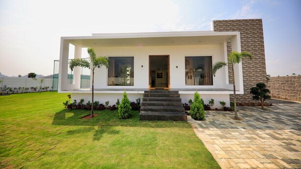 A modern two-story house with a flat roof, a front porch, and a paved driveway. - Neo Farm House with Pool, Beach Volley Ball & 5Beds(A/C) (Batasingaram)